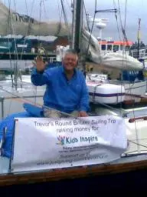 Trevor Nunn on his boat with the 'Kids Inspire' banner