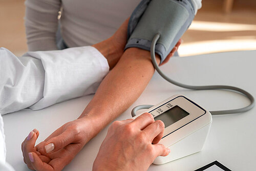 Pharmacist conducting a blood pressure check